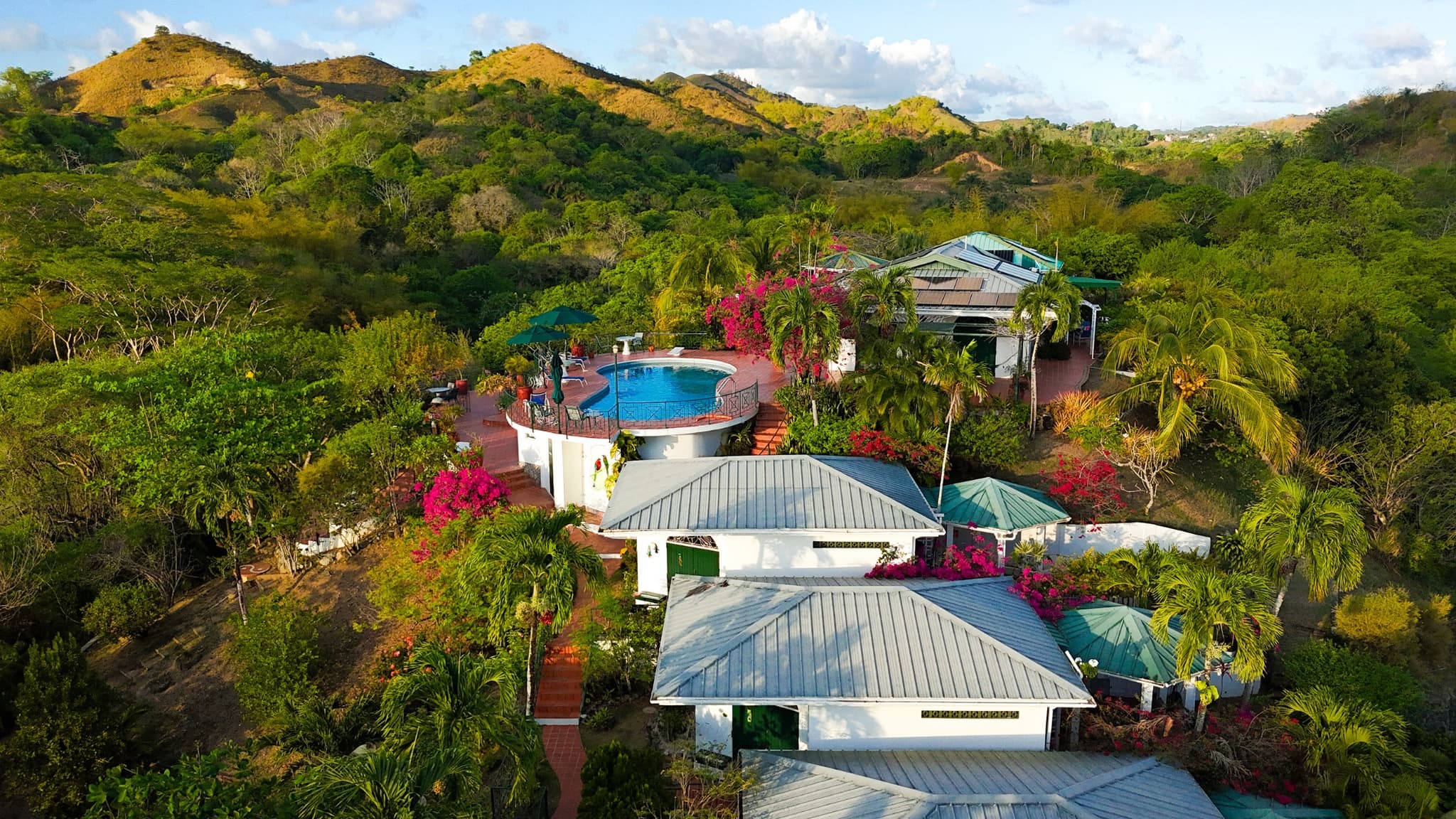 Aerial view of the Top O' Tobago property — main house, cabanas and pool set in six acres of gardens
